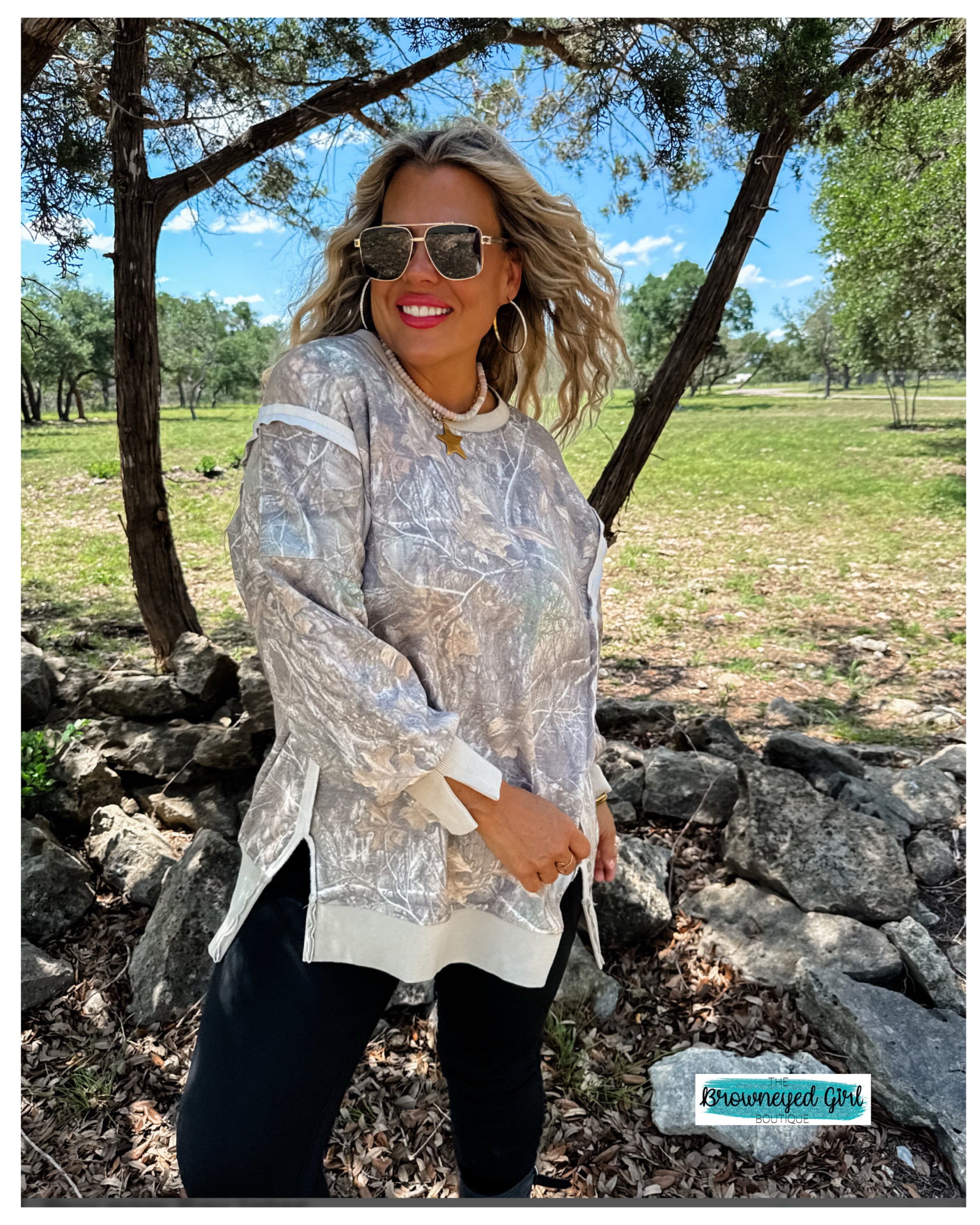Woman wearing a camo classic crew loose fit sweatshirt- blakeley