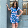 Woman Wearing Blue Floral Print Short Dress. Fit To Flare And Those Cute Side Pockets. This Dress Fits True To Size.