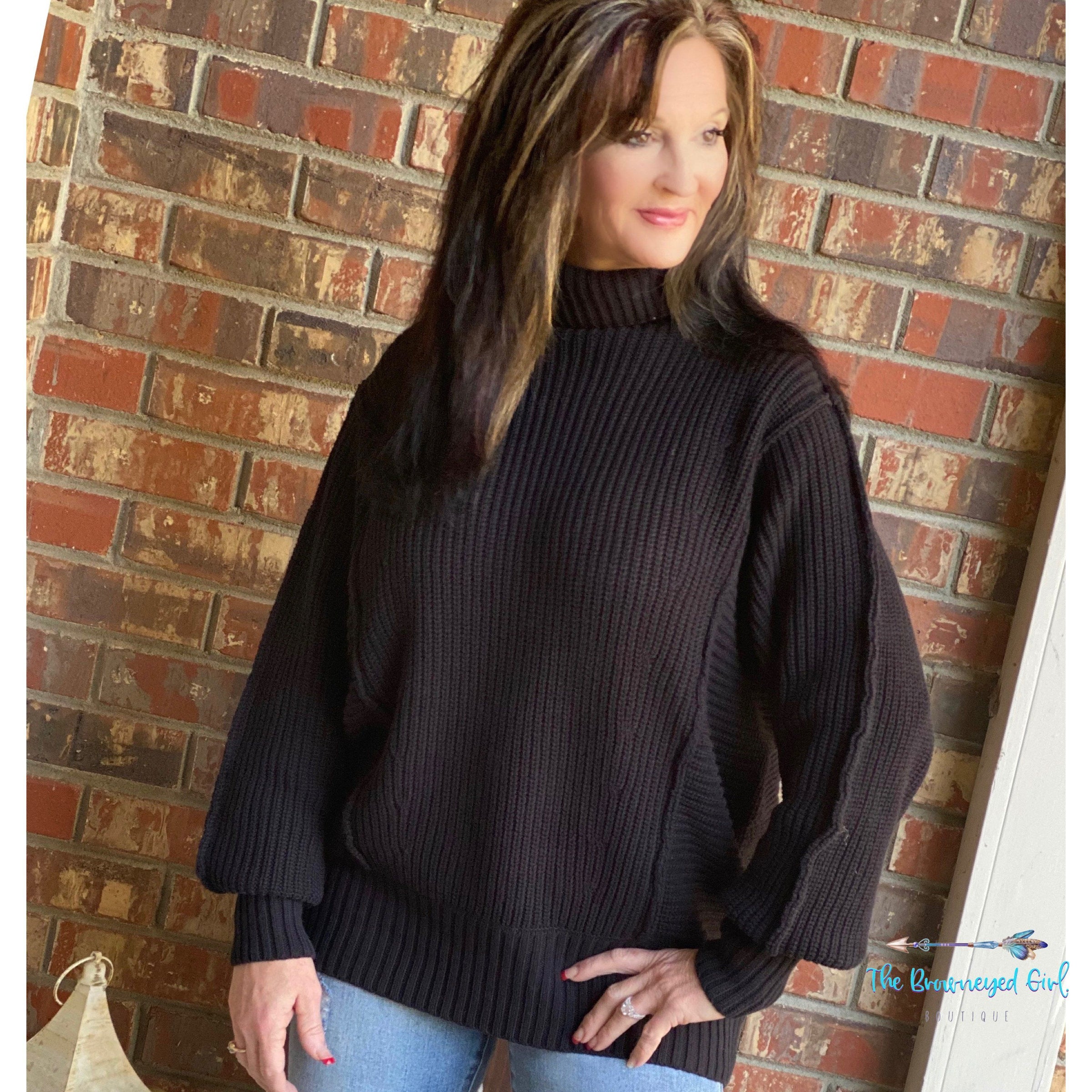 Woman wearing A Black Turtle Heavy Sweater With Stitching Detail Banded Cuffs And Hem