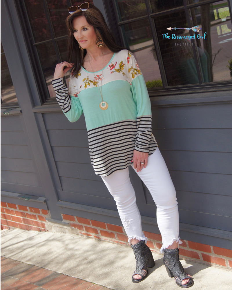 woman wearing A Spring Ivory,Mint, and stripe color block tunic. Rounded neck and hem line. Material iIs Soft And Stretchy USA MADE Plus Size  