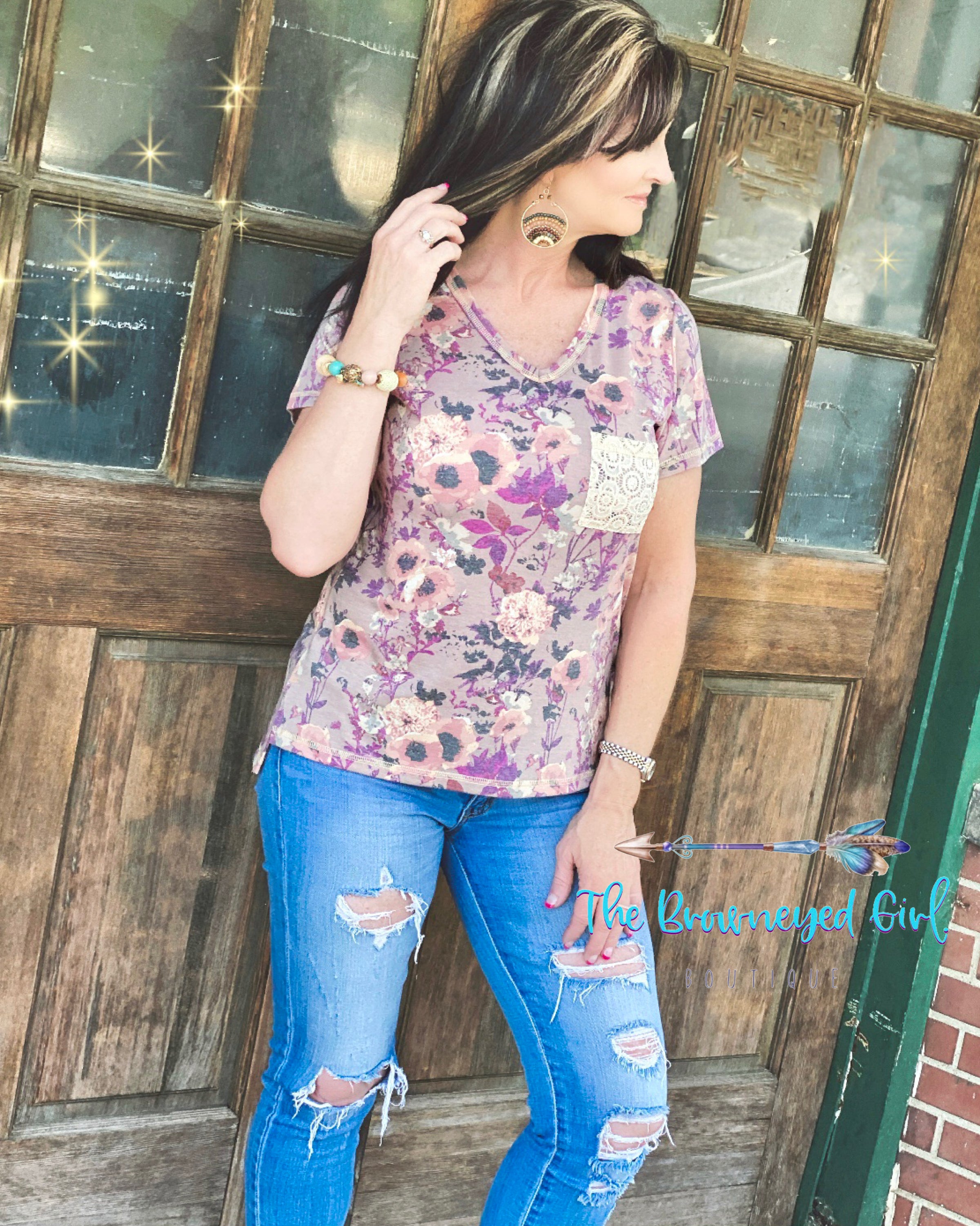 Woman wearing a v-neck mauve floral lace pocket tee. This top is short sleeve ultra comfortable pairs with denim and our Sierra Ribbed Knit Cardigan.  