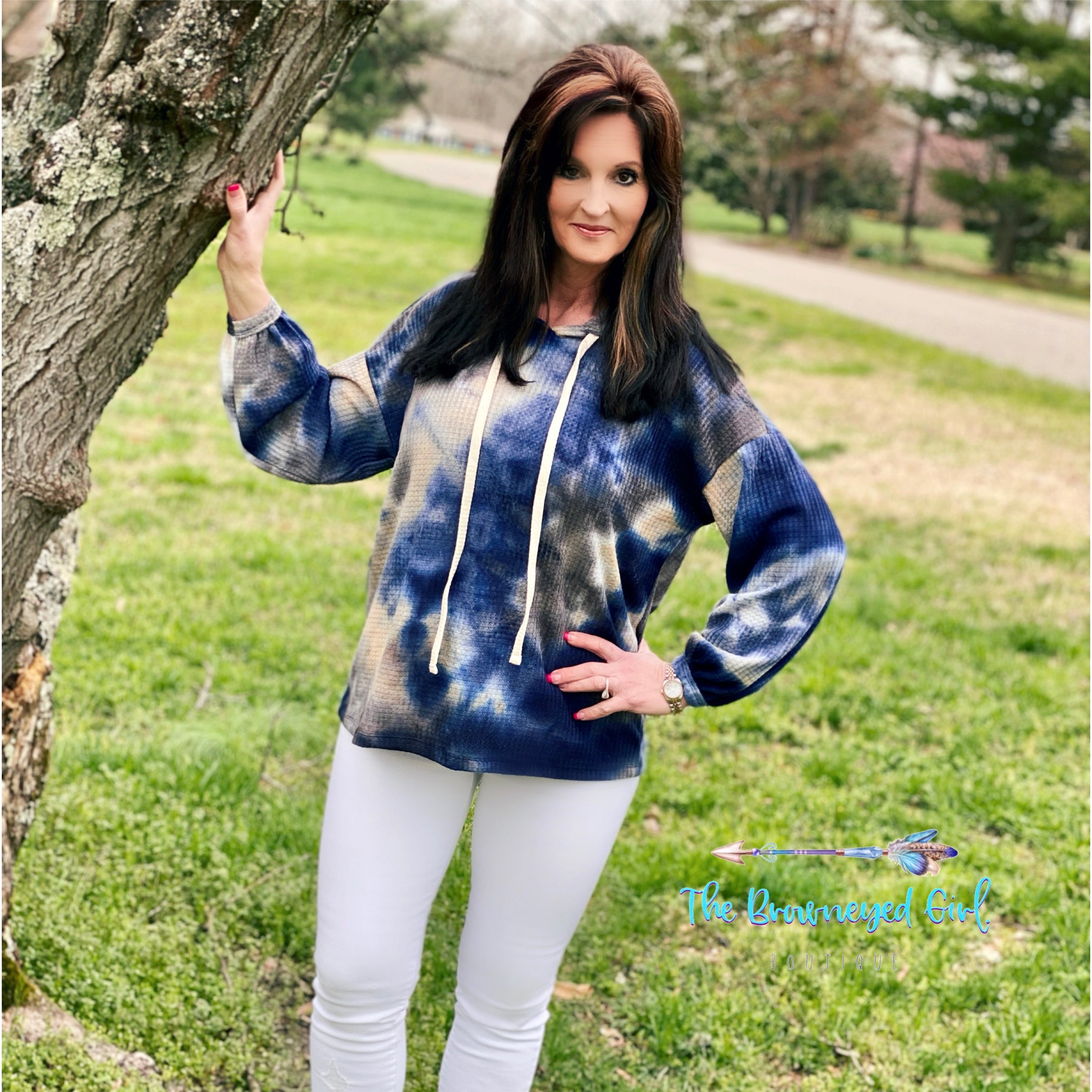 Women wearing a waffle knit tie-dye hoodie with bubble sleeves. Colors are cobalt blue, white,cream, and grey ,Ultra soft waffle knit fabric use Made Fits true to size. Model wearing size medium