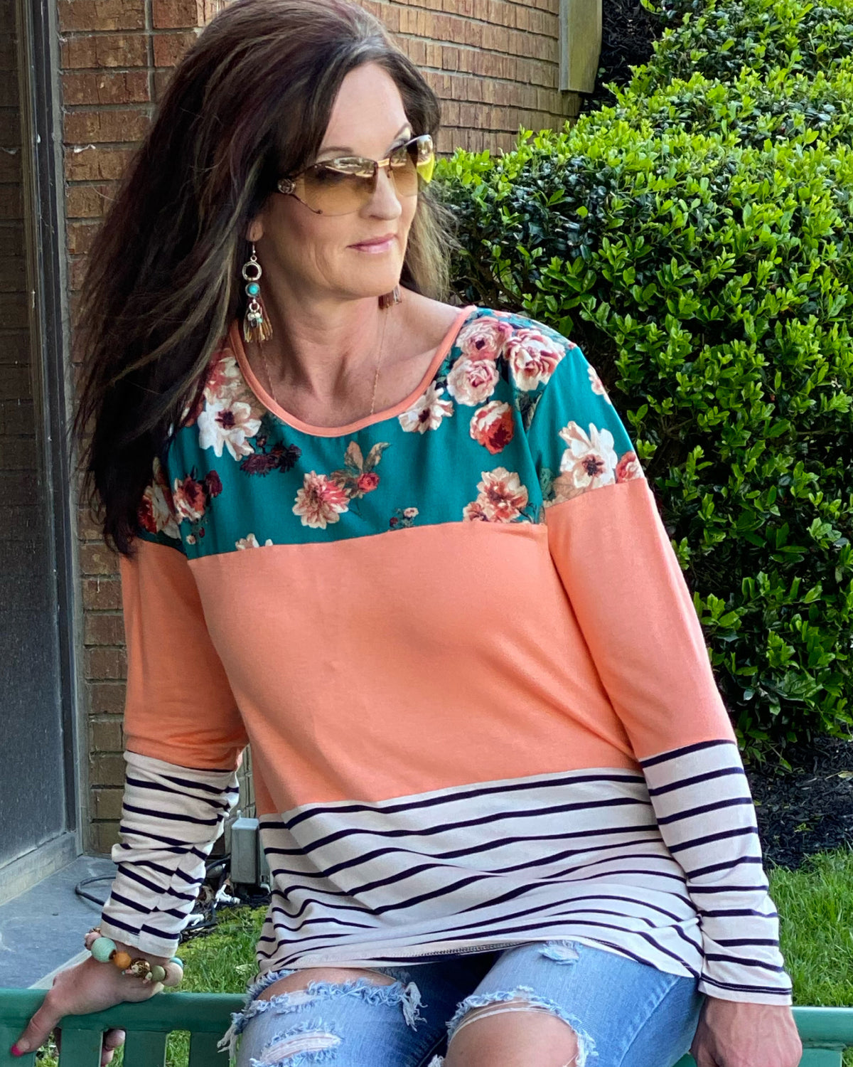 Woman wearing a color block tunic in teal, coral and stripe ,long sleeve .  This Top is Beautiful. Material is ultra soft and stretchy  fits true to size.