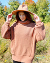 Woman Wearing A Camel Colored Heavy Knit Turtle Neck Sweater Premium Quality
